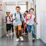 pupils running through school corridor